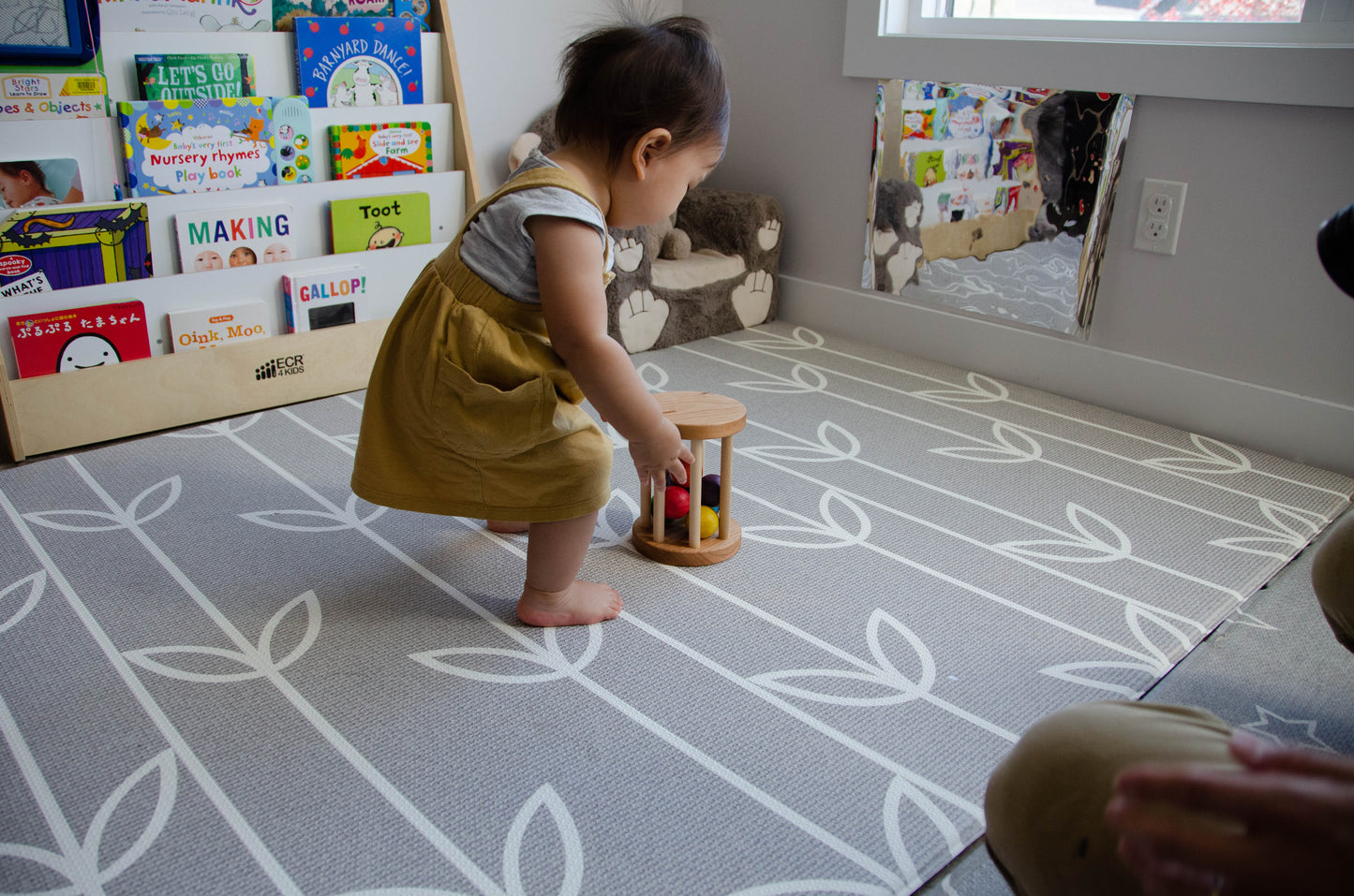 The little girl is happily picking up the Qualitmonti - Color Ball Cylinder toy. With enthusiasm and curiosity, she explores the colorful balls and the cylinder, captivated by the tactile and sensory experience the toy offers. As she engages with the different elements, she enhances her fine motor skills, hand-eye coordination, and color recognition. This interactive playtime encourages her learning and creativity while providing endless fun and exploration.