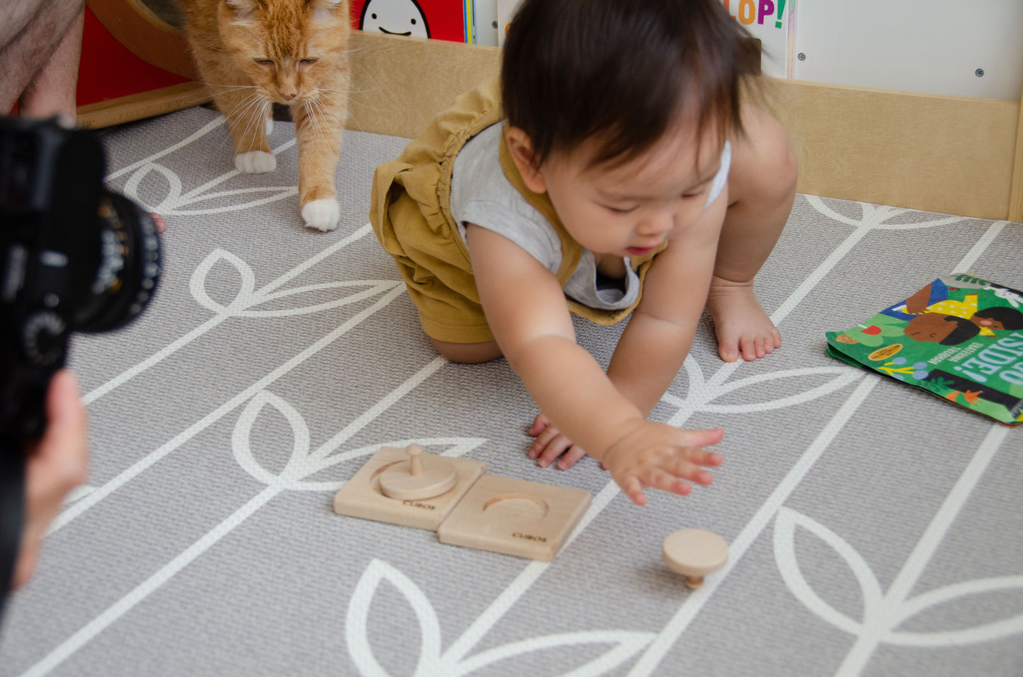 Adorable baby reaching out to grasp one of the circle puzzles from the Cubos 2 Different Size Circle Puzzle, eager to explore and play with the intriguing wooden toy.