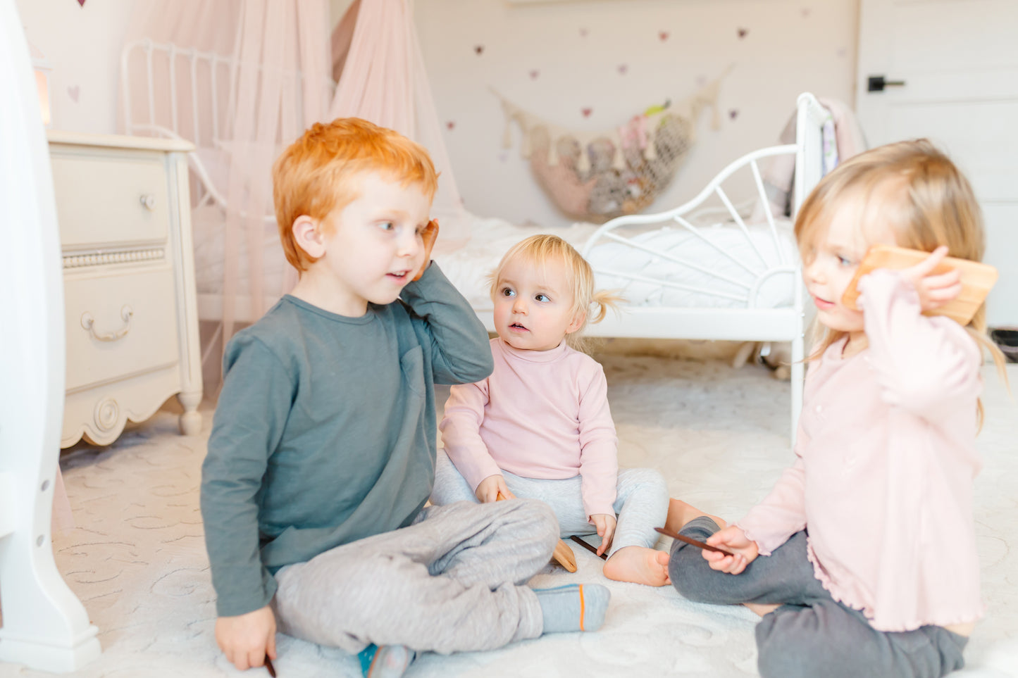 The little kids enthusiastically using iDoddle as if they are talking on the phone, showcasing their vivid imagination and creativity during playtime. Their imaginative play not only brings joy but also enhances their social and cognitive development as they engage in pretend conversations and role-playing scenarios with the interactive wooden toy.