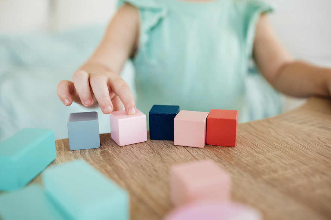 Little girl playing colorful cudes