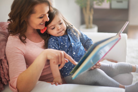 Mother and daughter reading book together