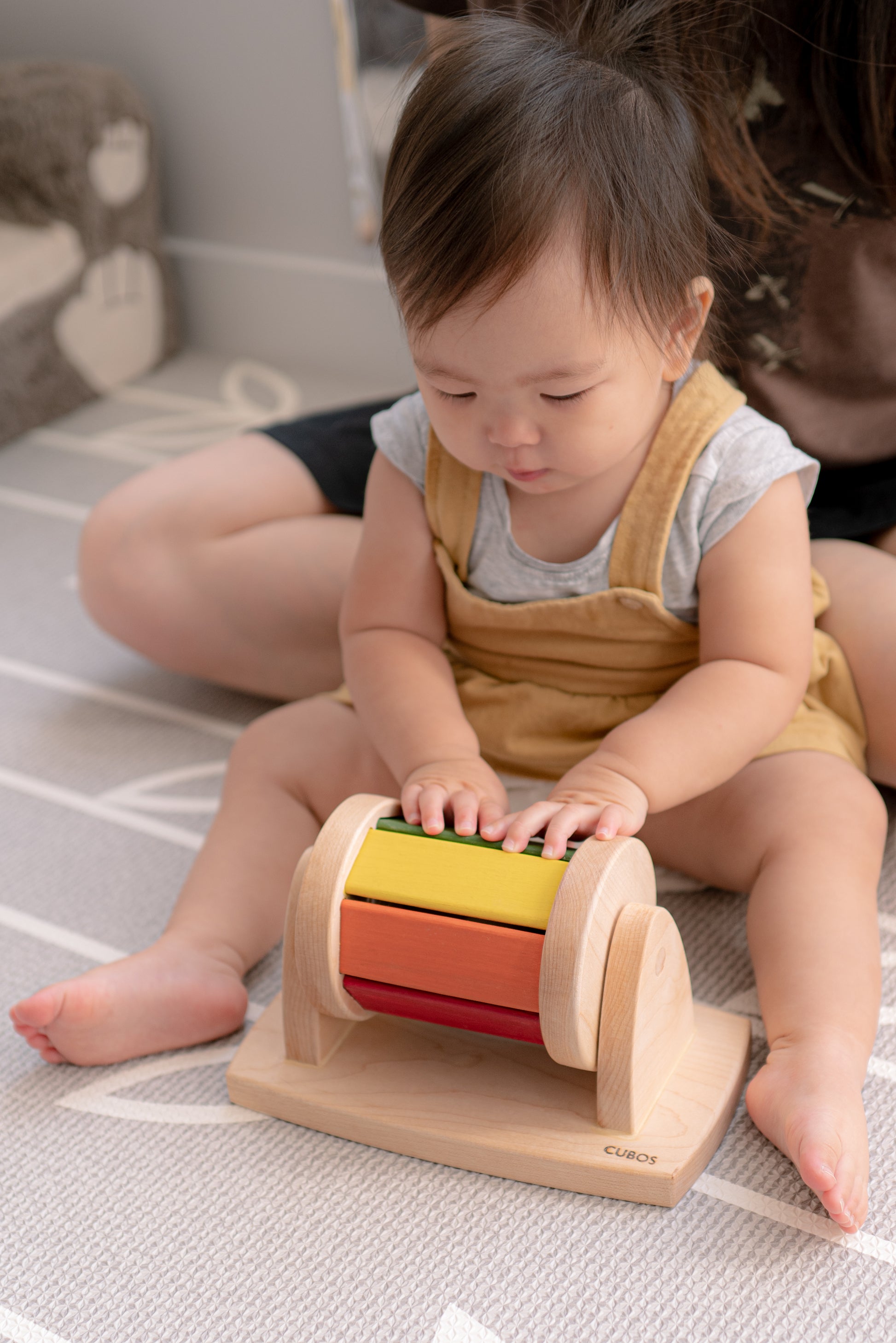 The little girl is joyfully playing with a spinning wheel toy. With excitement and wonder, she spins the wheel, watching it whirl around and captivated by its motion. This interactive playtime engages her senses and fosters her fine motor skills as she explores the spinning action and its effects. Her imaginative play with the spinning wheel sparks curiosity and creativity, making playtime a delightful and enriching experience for her.