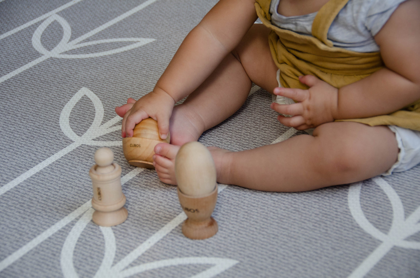 Baby happily playing with the Ball Bowl from the Cubos Ball Bowl Peg & Egg Cup set, enjoying the tactile experience and exploring its entertaining features."