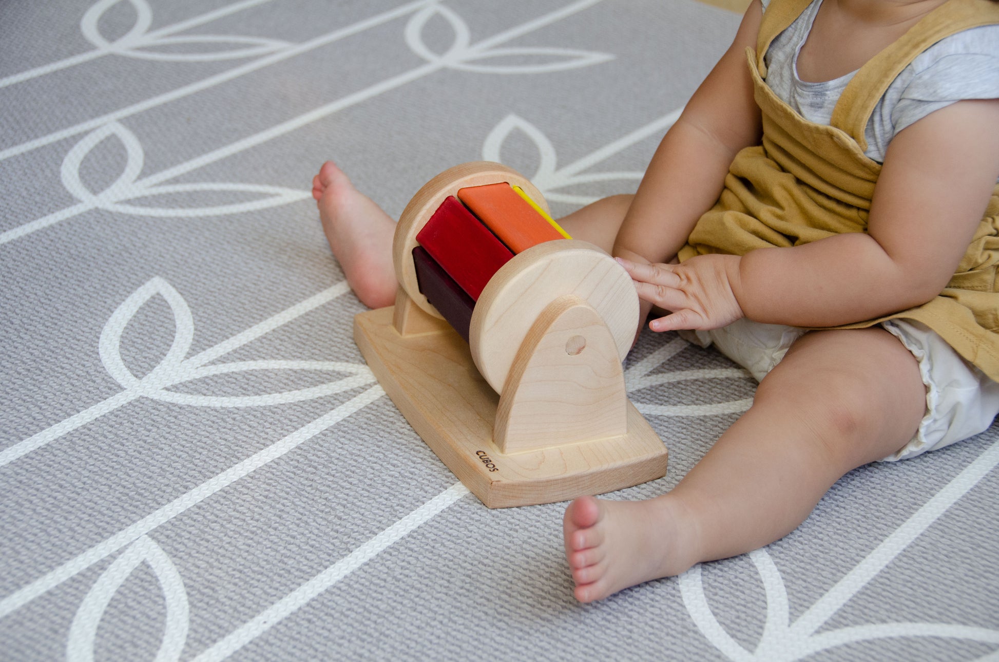 The little girl is joyfully playing with a spinning wheel toy. With excitement and wonder, she spins the wheel, watching it whirl around and captivated by its motion. This interactive playtime engages her senses and fosters her fine motor skills as she explores the spinning action and its effects. Her imaginative play with the spinning wheel sparks curiosity and creativity, making playtime a delightful and enriching experience for her.