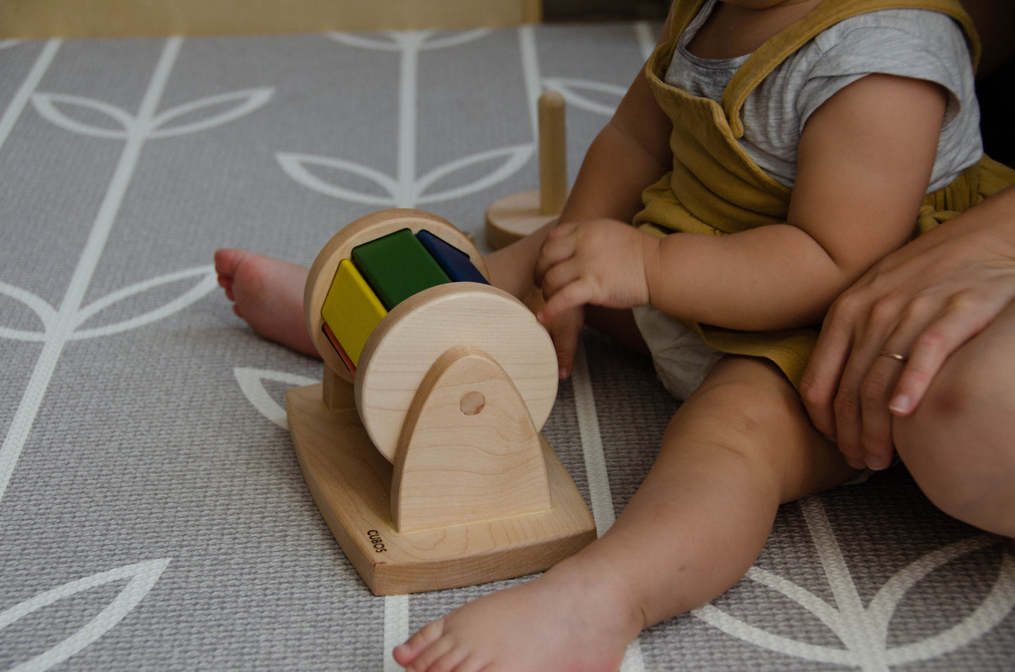 The little girl is joyfully playing with a spinning wheel toy. With excitement and wonder, she spins the wheel, watching it whirl around and captivated by its motion. This interactive playtime engages her senses and fosters her fine motor skills as she explores the spinning action and its effects. Her imaginative play with the spinning wheel sparks curiosity and creativity, making playtime a delightful and enriching experience for her.