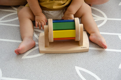 The little girl is joyfully playing with a spinning wheel toy. With excitement and wonder, she spins the wheel, watching it whirl around and captivated by its motion. This interactive playtime engages her senses and fosters her fine motor skills as she explores the spinning action and its effects. Her imaginative play with the spinning wheel sparks curiosity and creativity, making playtime a delightful and enriching experience for her.