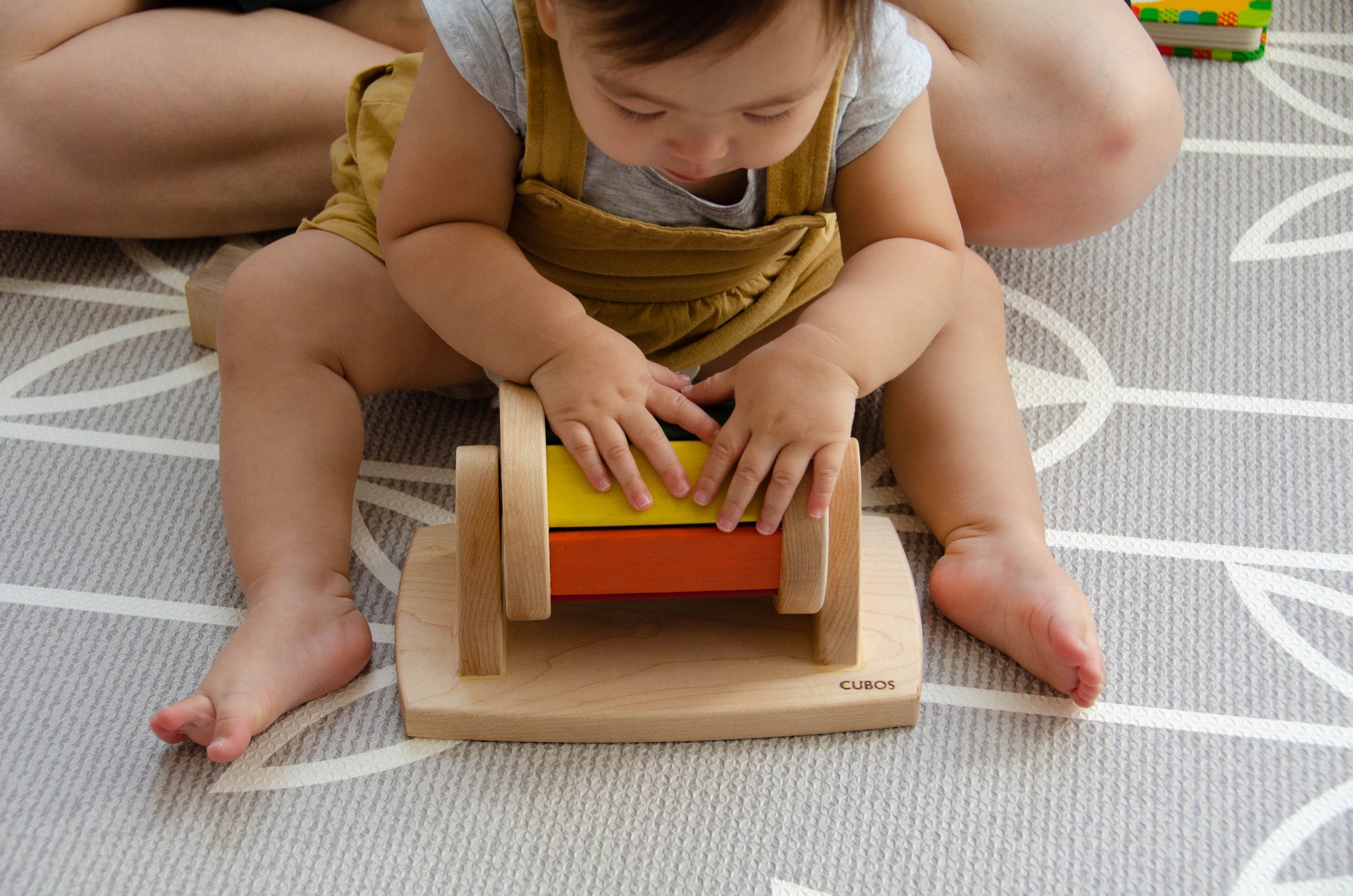 The little girl is joyfully playing with a spinning wheel toy. With excitement and wonder, she spins the wheel, watching it whirl around and captivated by its motion. This interactive playtime engages her senses and fosters her fine motor skills as she explores the spinning action and its effects. Her imaginative play with the spinning wheel sparks curiosity and creativity, making playtime a delightful and enriching experience for her.