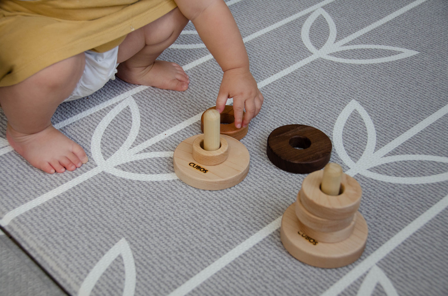 Little baby taking out rings from Cubos 3 Different Size Rings Stacker 
