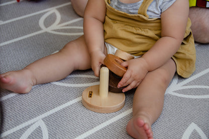 Curious baby skillfully removes all rings from the Cubos 3 Different Size Rings Stacker