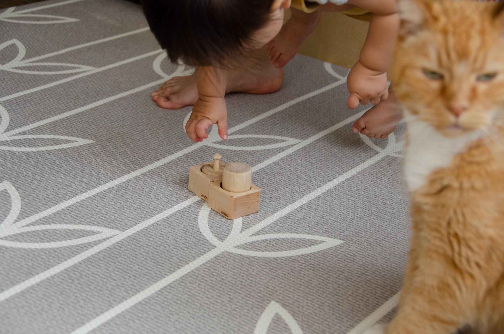 The baby girl is thoroughly enjoying her playtime with Cubos Pincer & Palmer Block. With her tiny hands, she skillfully manipulates the blocks, using the pincer grip to grasp and place them. This interactive and tactile play enhances her fine motor skills, hand-eye coordination, and cognitive development as she explores the different shapes and builds various structures. Her joyful engagement with the educational toy fosters early learning and creativity, making playtime an enriching experience for her.