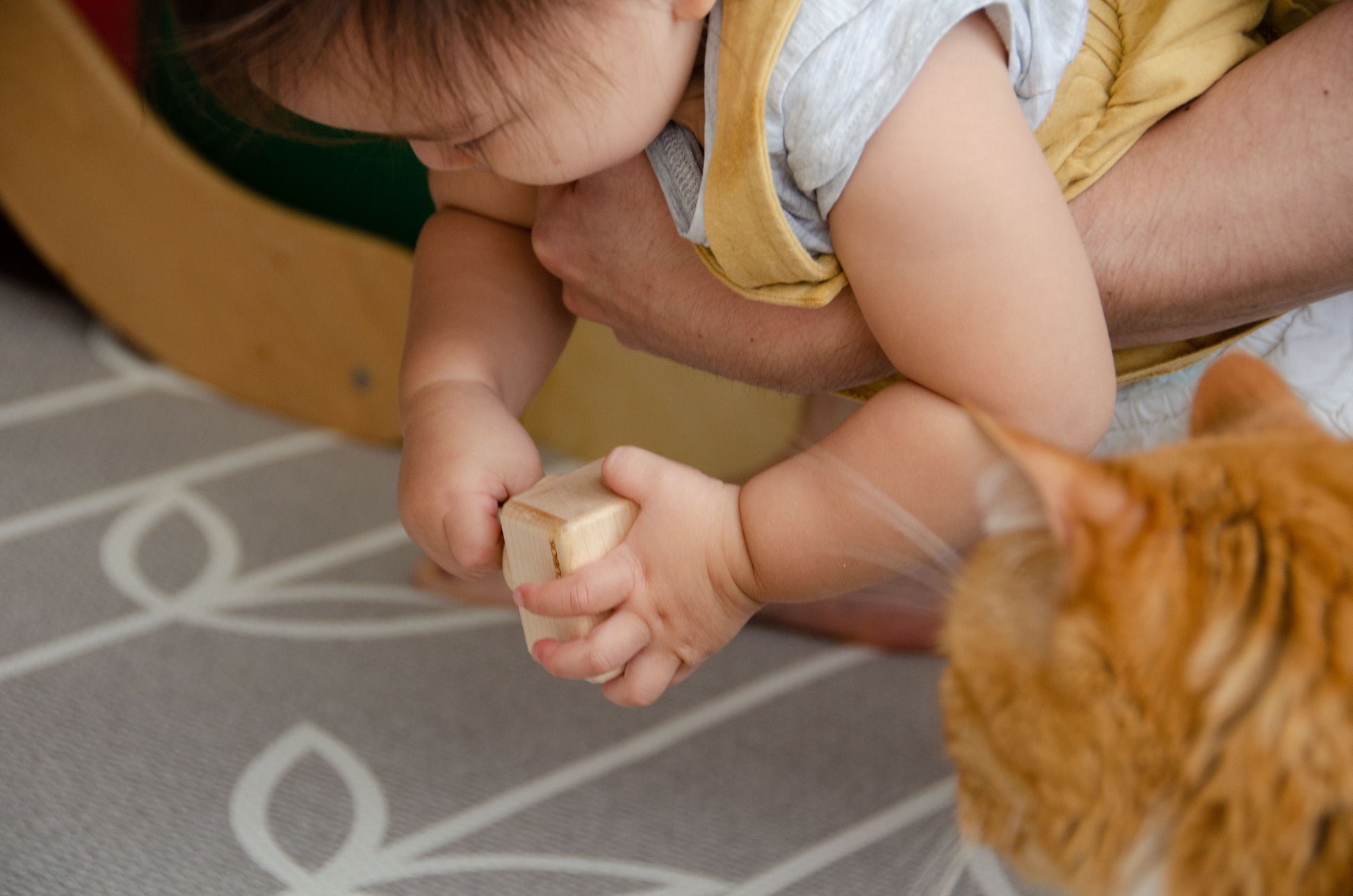 The baby girl is thoroughly enjoying her playtime with Cubos Pincer & Palmer Block. With her tiny hands, she skillfully manipulates the blocks, using the pincer grip to grasp and place them. This interactive and tactile play enhances her fine motor skills, hand-eye coordination, and cognitive development as she explores the different shapes and builds various structures. Her joyful engagement with the educational toy fosters early learning and creativity, making playtime an enriching experience for her.