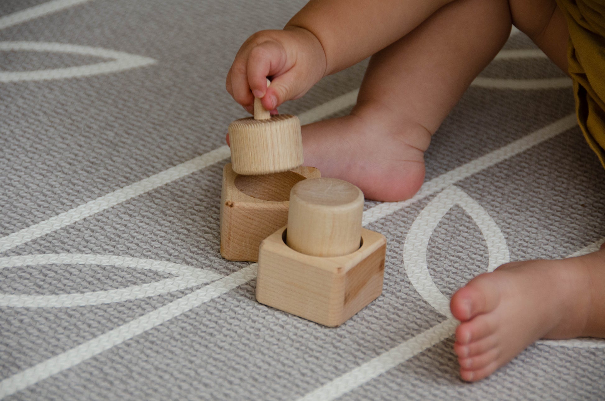 The baby girl is thoroughly enjoying her playtime with Cubos Pincer & Palmer Block. With her tiny hands, she skillfully manipulates the blocks, using the pincer grip to grasp and place them. This interactive and tactile play enhances her fine motor skills, hand-eye coordination, and cognitive development as she explores the different shapes and builds various structures. Her joyful engagement with the educational toy fosters early learning and creativity, making playtime an enriching experience for her.