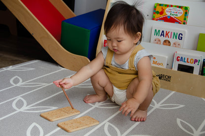 A sweet little girl confidently holding a wooden pen and using iDoddle to practice writing numbers. With focus and determination, she explores the world of numerals, building her fine motor skills and number recognition in a playful and interactive manner. Her curiosity and early learning efforts are a testament to the wonders of childhood exploration and imagination.