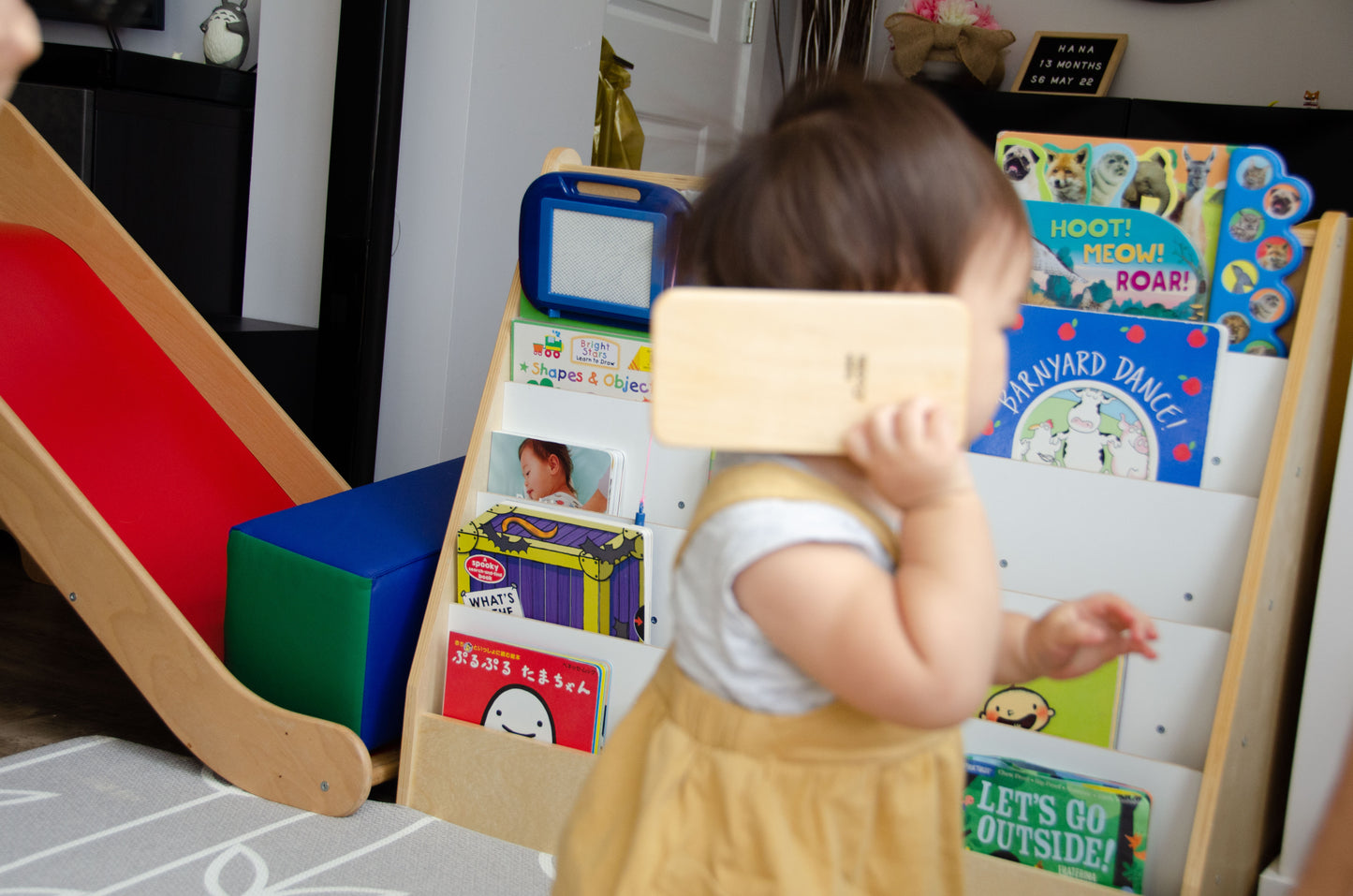 The adorable little girl is having a wonderful time playing with her iDoddle. She uses it to draw, write, and explore her creativity, but also enjoys pretending that the iDoodle is a phone. With her imagination at play, she engages in delightful conversations and imaginative scenarios, making the most out of her cherished wooden toy. This kind of play fosters her artistic skills, communication abilities, and imaginative thinking, providing a fun and enriching experience for her.