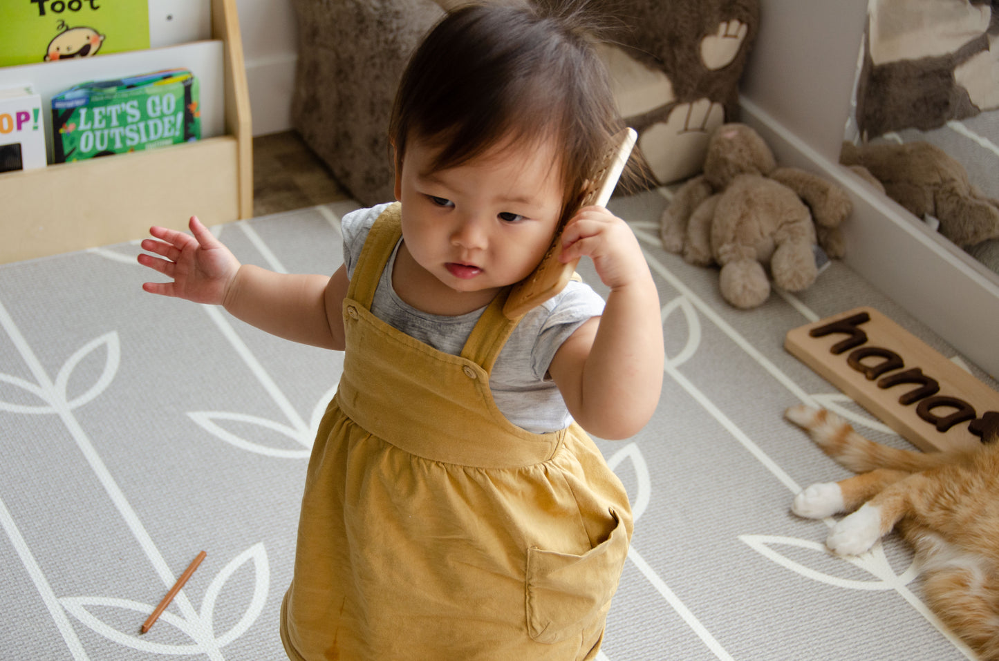 The adorable little girl is having a wonderful time playing with her iDoddle. She uses it to draw, write, and explore her creativity, but also enjoys pretending that the iDoodle is a phone. With her imagination at play, she engages in delightful conversations and imaginative scenarios, making the most out of her cherished wooden toy. This kind of play fosters her artistic skills, communication abilities, and imaginative thinking, providing a fun and enriching experience for her.