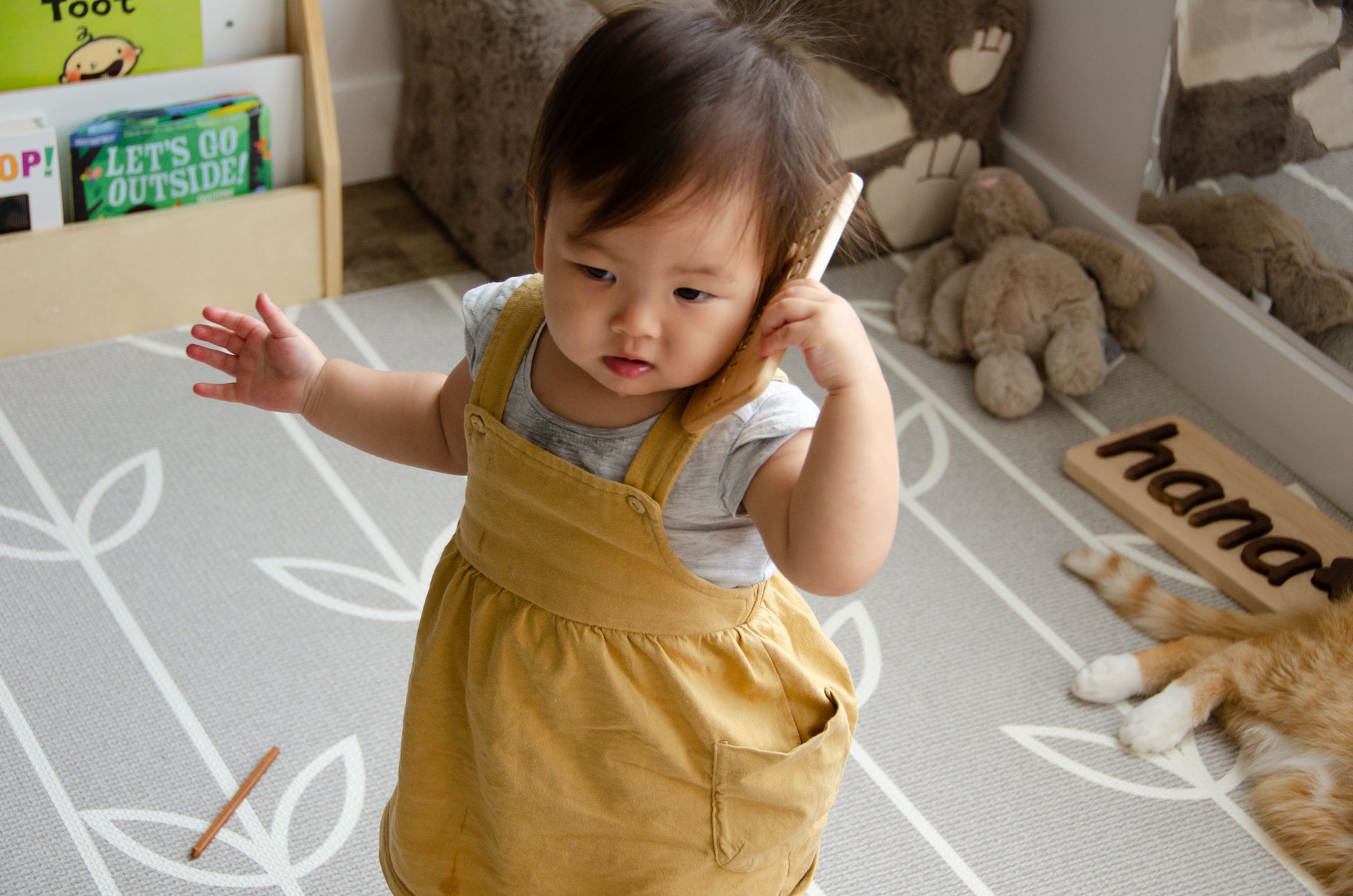 The adorable little girl is having a wonderful time playing with her iDoddle. She uses it to draw, write, and explore her creativity, but also enjoys pretending that the iDoodle is a phone. With her imagination at play, she engages in delightful conversations and imaginative scenarios, making the most out of her cherished wooden toy. This kind of play fosters her artistic skills, communication abilities, and imaginative thinking, providing a fun and enriching experience for her.