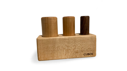 3 Pegs Palmer - A wooden toy with three pegs of different heights, designed to support grasping and fine motor skills development in Montessori education