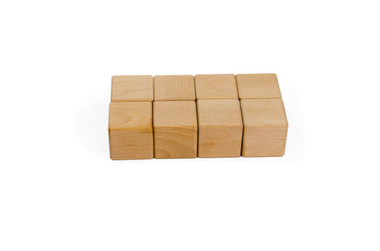 8 Wooden Cubes - A set of eight wooden cubes of the same size and shape, ideal for hands-on exploration, stacking, and spatial awareness in Montessori education.